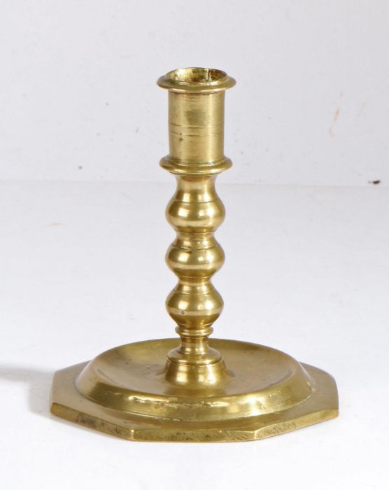 A late 17th century brass candlestick, circa 1680 Having a straight-sided socket with narrow flange,