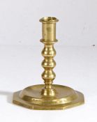 A late 17th century brass candlestick, circa 1680 Having a straight-sided socket with narrow flange,