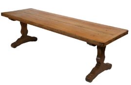 A beech trestle table In the 16th century manner, having an end-cleated top of two thick boards,
