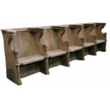 An oak choir stall, in the mid-15th century manner Comprising a run of five seats, each with leafy-