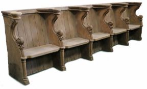 An oak choir stall, in the mid-15th century manner Comprising a run of five seats, each with leafy-