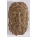 A small carved stone head Designed as Christ, 13cm long