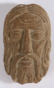 A small carved stone head Designed as Christ, 13cm long