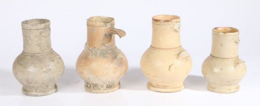 Four 18th century stoneware jugs Each with wide neck and bulbous body,  above a slightly splayed