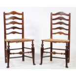 A Pair of George III ladder-back dining chairs, the shaped splats above rush seats, on shell