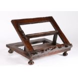 An interesting, possibly padouk/walnut, adjustable book rest, circa 1700 The open frame