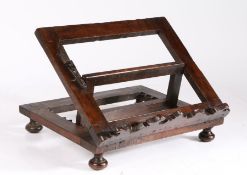 An interesting, possibly padouk/walnut, adjustable book rest, circa 1700 The open frame
