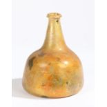 An early 18th century glass onion bottle, English, 1700-1720 Orange lustre to the glass, inverted