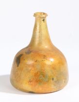 An early 18th century glass onion bottle, English, 1700-1720 Orange lustre to the glass, inverted