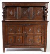 An early 17th century oak court cupboard, English, circa 1600-30 With simple moulded cornice, and