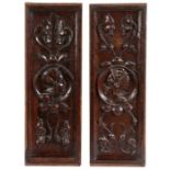 A pair of 16th century oak Romayne-type carved panels, circa 1540 Each panel with a roundel helmeted
