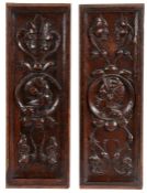 A pair of 16th century oak Romayne-type carved panels, circa 1540 Each panel with a roundel helmeted