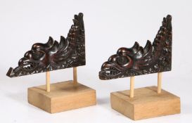 A pair of 16th century spandrels, mounted Each designed as a cockatrice, carved to both sides, on