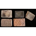 A collection of four 16th century fire place bricks, Belgian The first decorated with scrolls,