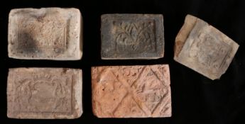 A collection of four 16th century fire place bricks, Belgian The first decorated with scrolls,