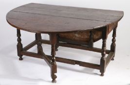 A large oak gateleg table, English, circa 1700 Having an oval drop-leaf top, and single end-frieze