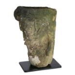 An unusual carved Medieval stone head The top hollowed out for offerings, above a bearded face, 40cm
