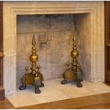 An impressive pair of brass andirons, circa 1800 Each with a stem topped by a prominent reeded-