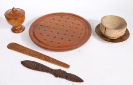 A collection of treen To include a solitaire board, two page turners, a lidded spice pot, a