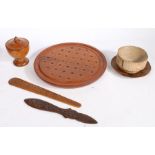 A collection of treen To include a solitaire board, two page turners, a lidded spice pot, a