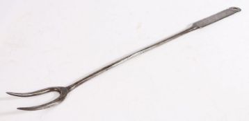 A George II iron meat fork, circa 1750 With two tines, plain stem and flattened handle with