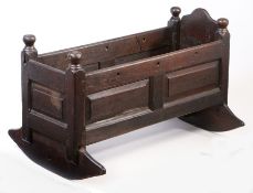 A William & Mary oak crib, circa 1690 Of fielded panelled construction, the uprights with large