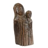 A primitive oak carving of the Virgin and child  Modelled in drapped robes, 51cm high