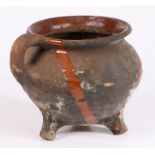 A 17th century Dutch pottery cauldron With ribbed body, loop handles and three dumpy feet,