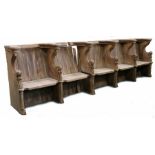 An oak choir stall, in the mid-15th century manner Comprising a run of five seats, each with leafy-