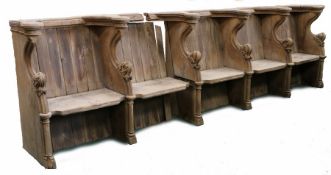 An oak choir stall, in the mid-15th century manner Comprising a run of five seats, each with leafy-