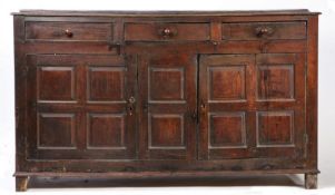 A George III oak fully-enclosed oak dresser base, circa 1760 The boarded top with shallow broad rear