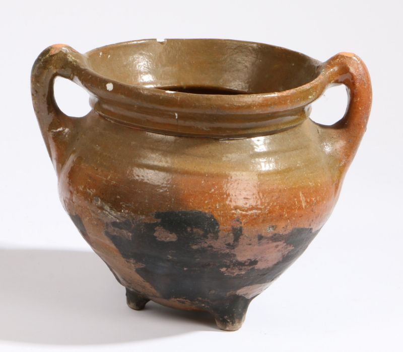 A 17th century Dutch pottery cauldron With a ribbed body and loop handles, on three dumpy feet, 18cm - Image 2 of 2