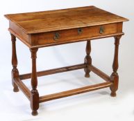 An 18th century walnut side table The boarded top with ovolo-moulded edge, flush frieze drawer, on