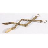 A pair of early 19th century brass ‘lazy-tongs’, English Of extending and retracting scissor form,