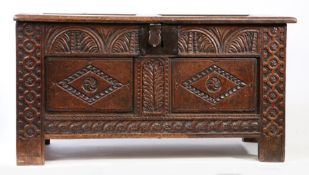 A James I/Charles I oak coffer, West Country, circa 1620-30 Having a twin-panelled hinged lid, the