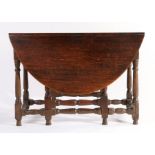 An 18th century oak drop-leaf table, English Having an oval drop-leaf top, wavy frieze, turned