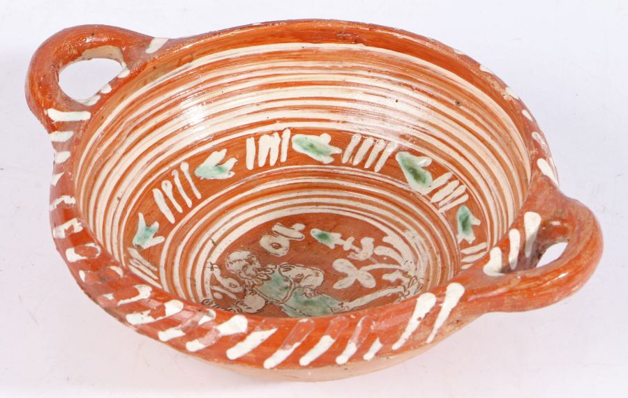 A Dutch slipware twin-handled bowl, dated 1604 The centre with a figure walking amongst trees, a - Image 3 of 4