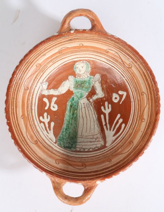 A Dutch slipware twin handled bowl, dated 1607 The centre of the bowl with a standing female - Image 2 of 3