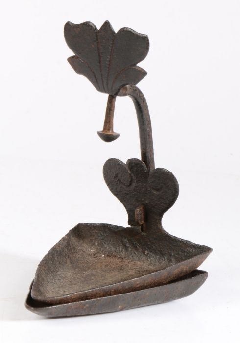 A late 18th -early 19th century iron cruisie lamp With typical triangular-shaped two-stage