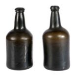 A near pair of 18th century bottles The green glass dumpy bottles with pontil marks to the bases,