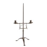 A late 18th century wrought iron standing candleholder, English Having a pair of adjustable height