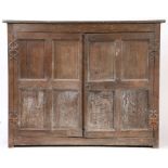 An early 17th century joined oak side cupboard, West Country Having an elm one-piece top board,