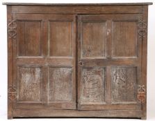 An early 17th century joined oak side cupboard, West Country Having an elm one-piece top board,