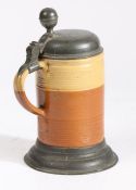 A mid-18th century pewter-mounted earthenware stein, German The domed lid engraved with initials and