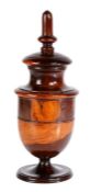 A George III lignum vitae coffee grinder, circa 1790 Having a tall finial above an urn-shaped body