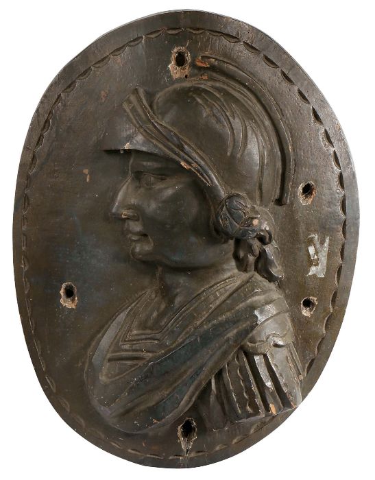 A 17th century carved elm oval panel Designed as a Renaissance solider, 39cm wide, 52cm high