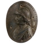 A 17th century carved elm oval panel Designed as a Renaissance solider, 39cm wide, 52cm high