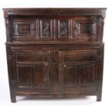 A 17th century oak court cupboard, English, dated ‘1693' Having a run-moulded frieze on inverted-