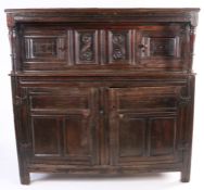 A 17th century oak court cupboard, English, dated ‘1693' Having a run-moulded frieze on inverted-