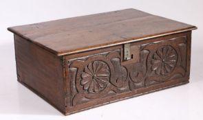 A Charles II oak boarded box, circa 1660 Having a one-piece lid, the front boldly carved with two